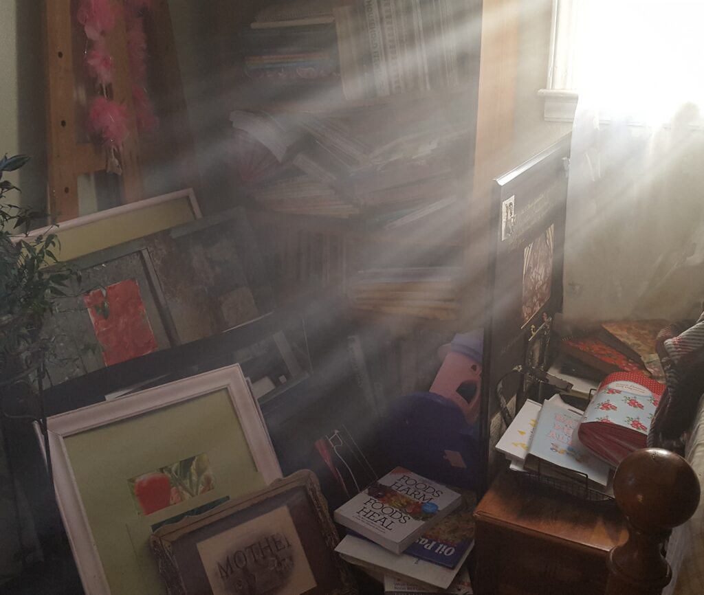 image of rays of sunshine streaming across a stack of art